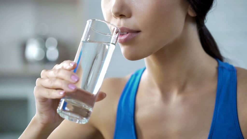 A woman drinking water from a glass