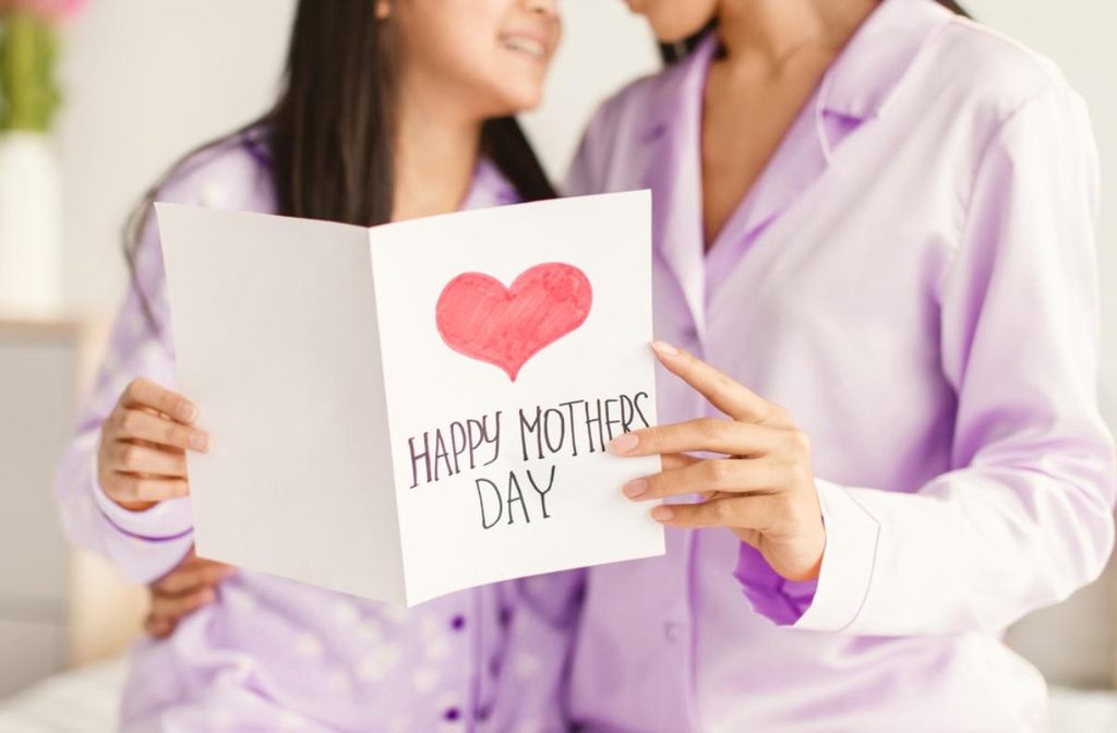 Mother receiving a special Mother's Day card along with a water purifier health gift from her daughter.